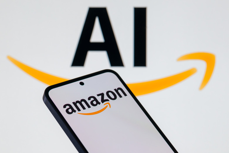 The Amazon.com logo is displayed on a mobile phone with artificial intelligence (AI) in the background, in this photo illustration in Brussels, Belgium, on October 28, 2025. (Photo Illustration by Jonathan Raa/NurPhoto via Getty Images)