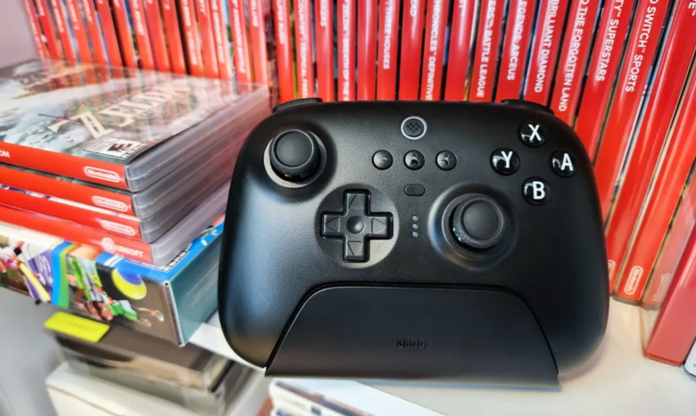 A video game controller next to sweet collection of Switch games.