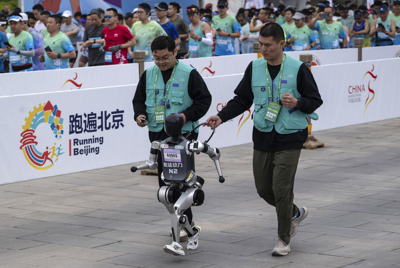 BEIJING, CHINA - APRIL 19: A Humanoid robot runs in the Beijing E-Town Humanoid Robot Half Marathon on April 19, 2025 in Beijing, China. According to organizers, the event was the first of its kind and featured twenty-one humanoid robot runners.  (Photo by Kevin Frayer/Getty Images)