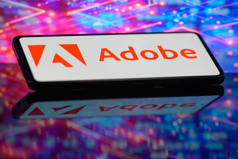 The Adobe logo is being displayed on a smartphone in this photo illustration in Brussels, Belgium, on June 10, 2024. (Photo Illustration by Jonathan Raa/NurPhoto via Getty Images)