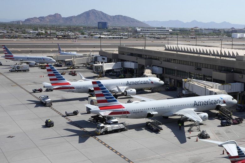 FILE - American Airlines planes wait at gates at Phoenix Sky Harbor International Airport Friday, July 19, 2024, in Phoenix. (AP Photo/Ross D. Franklin, File)