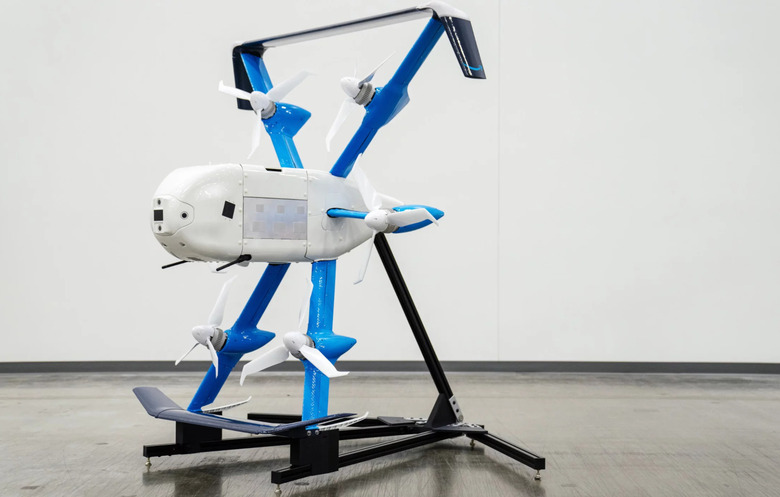 A white and blue drone propped against a stand.