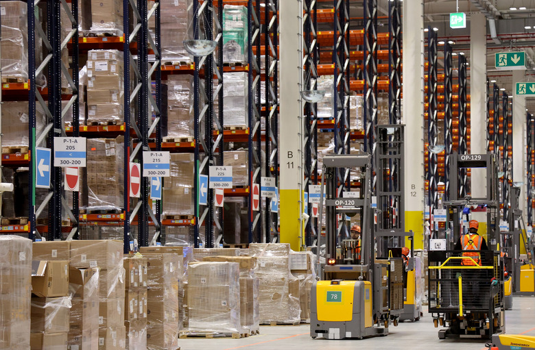 PRODUCTION - 27 November 2024, Mecklenburg-Western Pomerania, Dummerstorf: In Amazon's new logistics center, industrial trucks are on the move in the high-bay warehouse. The new center was officially opened in September. Around 500 people currently work at the site, and this figure is set to rise to 1,000 in the future. Around 1 million items are currently stored at the site. Photo: Bernd Wüstneck/dpa (Photo by Bernd Wüstneck/picture alliance via Getty Images)