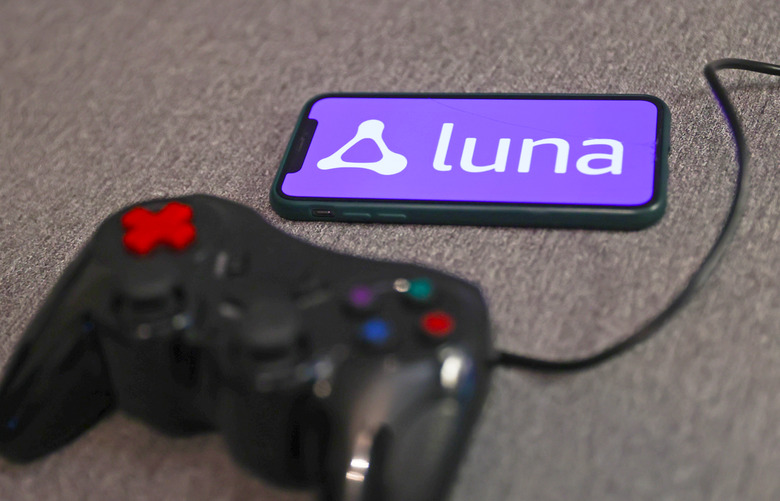Luna logo displayed on a phone screen and a gamepad are seen in this illustration photo taken in Krakow, Poland on September 29, 2022. (Photo by )