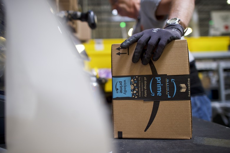 ROBBINSVILLE, NJ - AUGUST 1:  A worker boxes orders at the Amazon Fulfillment Center on August 1, 2017 in Robbinsville, New Jersey.  The more than 1 million square feet facility holds tens of millions of products, features more than 14 miles of conveyor belts, and employs more than 4,000 workers who pick, pack, and ship orders.  Tomorrow Amazon will host a jobs fair to hire 50,000 positions in their fulfillment centers nationwide.  (Photo by Mark Makela/Getty Images)