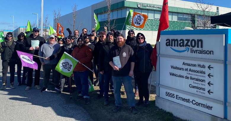 Amazon workers celebrate outside a warehouse in Laval, Quebec after forming a union.