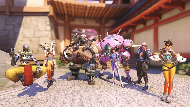 Overwatch heroes Zenyatta, Mercy, Roadhog, Soldier: 76 and Tracer shown in their original  skins on the Hanamura map.