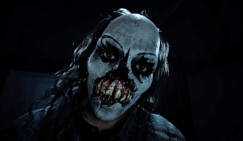 A figure wearing a creepy and bloody evil clown mask is shown in the promo image for the video game Until Dawn.