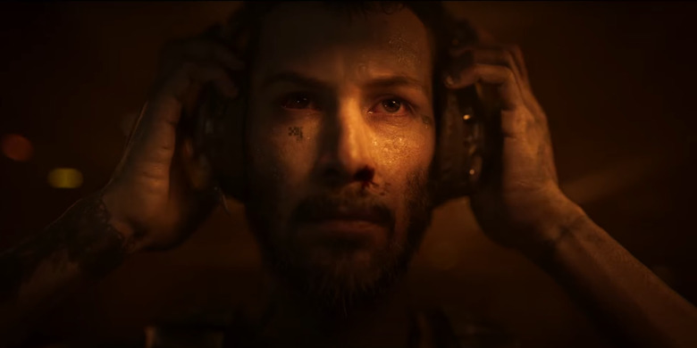 An animated version of Keanu Reeves taking off a headset in Secret Level.