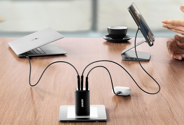 Anker's 735 USB-C charger with an earphone case, laptop and tablet connected simultaneously.