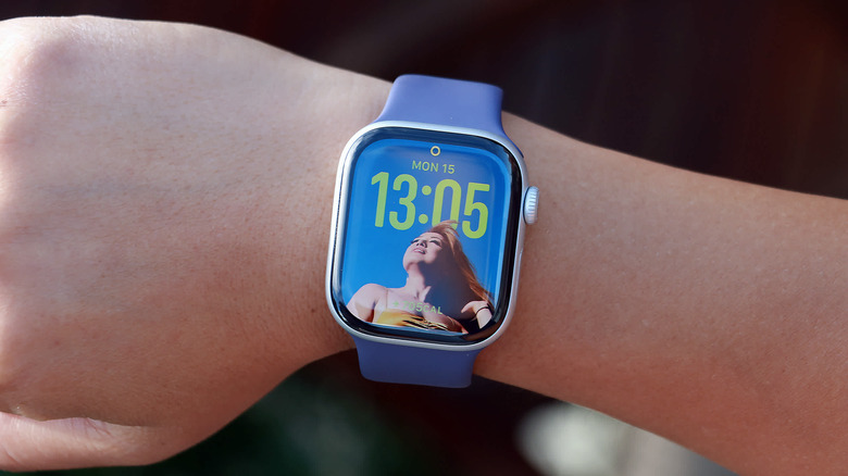 apple watch series 11 on a persons wrist with a pretty lady on the watch face a 1:05 pm
