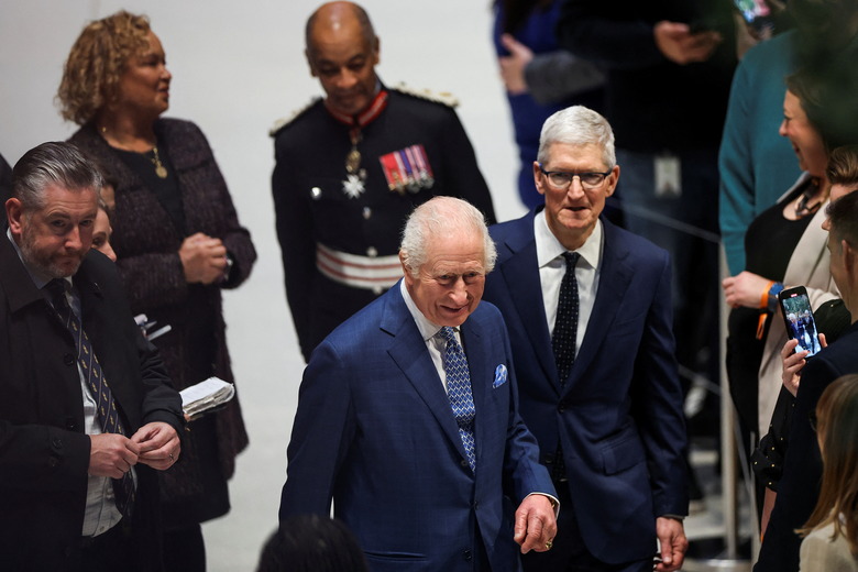 Britain's King Charles and CEO of Apple, Tim Cook walk at Apple's UK Head Office at Battersea Power Station in London, Britain, December 12, 2024. REUTERS/Toby Melville
