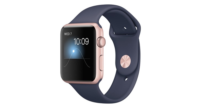 A rose gold Series 1 Apple Watch with a navy silicon band displaying the sun time animation