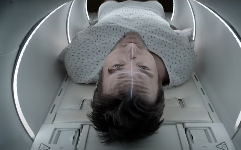 A still showing a man in an MRI machine.