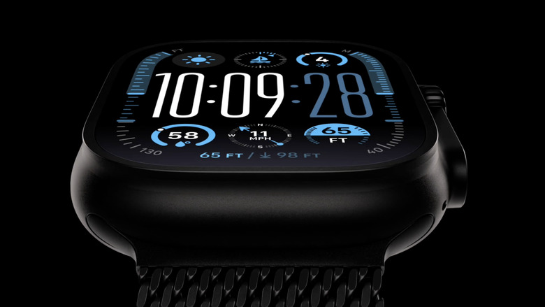 A black Apple Watch pictured close up against a black background 