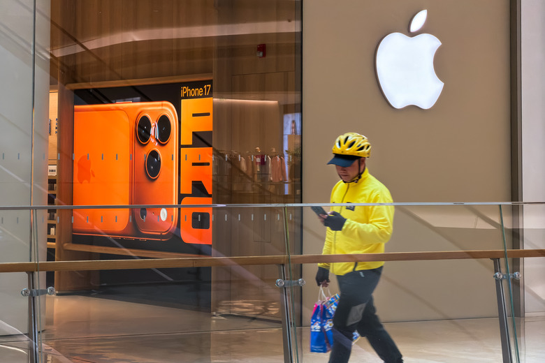 Delivery Worker Passes Apple Store With iPhone 17 Advertisement In Shenzhen
