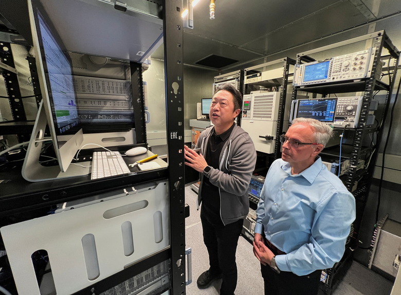 Johny Srouji (R), senior vice president of hardware technologies at Apple, and an Apple engineer view testing data on Apple's new C1 cellular modem in a shield room that blocks interference from cellular networks at Apple's wireless labs, in Sunnyvale, California, U.S., February 18, 2025. REUTERS/Stephen Nellis