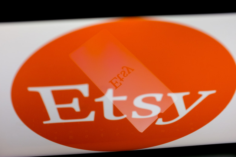 The Etsy logo is displayed on a smartphone screen and on a computer screen in Athens, Greece, on April 23, 2024. (Photo by Nikolas Kokovlis/NurPhoto via Getty Images)