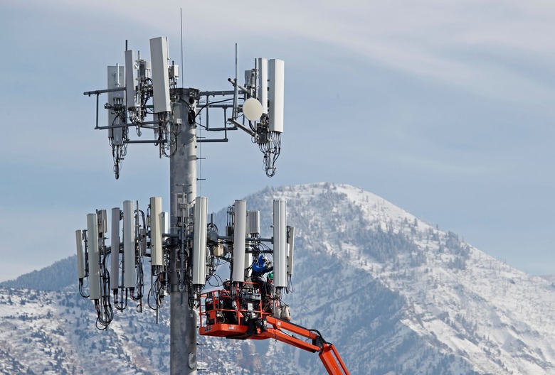 TOPSHOT - A contract crew for Verizon, works on a cell tower to update it to handle the new 5G network in Orem, Utah on December 10,  2019. - The new 5G cellular network will substantially increase cellular network speeds, opening up new markets for business and individuals. (Photo by GEORGE FREY / AFP) (Photo by GEORGE FREY/AFP via Getty Images)