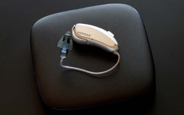 A Phonak Audeo B-Direct hearing aid of Swiss manufacturer Sonova lies on a Phonak TV Connector device in Staefa, Switzerland August 16, 2017. REUTERS/Arnd Wiegmann