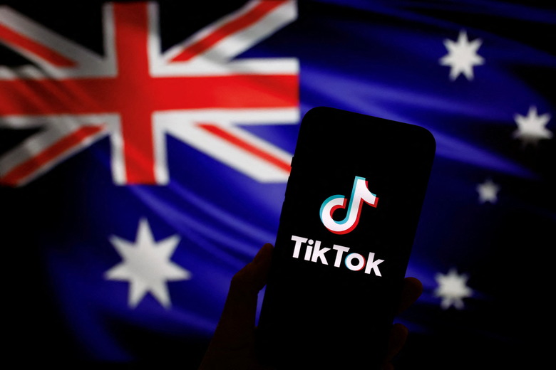 The logo of Chinese-owned video app TikTok is seen on a smartphone in front of an image of the Australian national flag in this illustration picture taken April 4, 2023. REUTERS/Tingshu Wang/Illustration