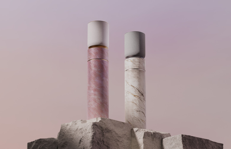 Speakers on pink and white marble plinths.