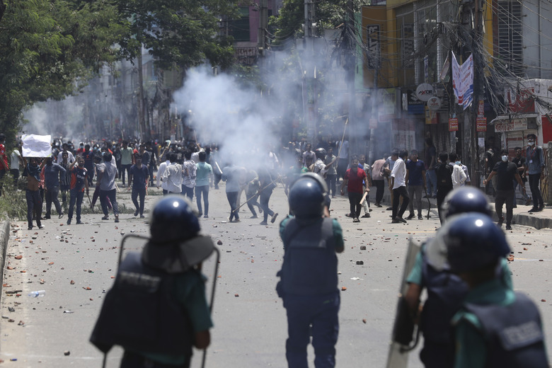 Students clash with riot police during a protest against a quota system for government jobs, in Dhaka, Bangladesh, Thursday, July 18, 2024. (AP Photo/Rajib Dhar)