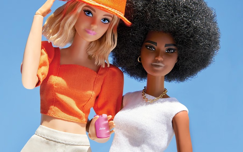 Two Barbies posed next to each other, with one holding a pink Barbie branded filp phone