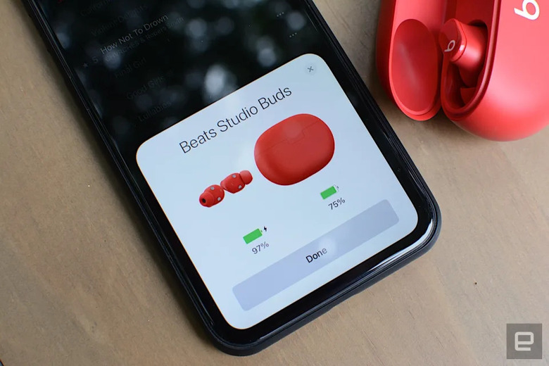 Beats Studio Buds in red pairing with a phone