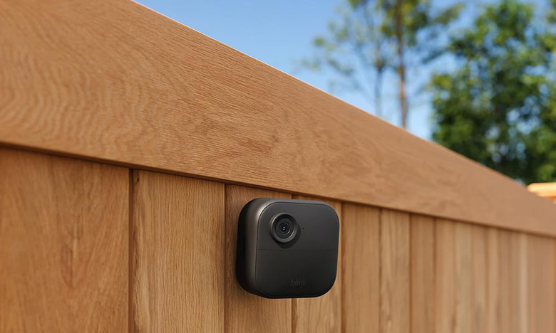 The Blink Outdoor 4 camera is mounted to a fence, keeping a watchful eye on the back yard. 