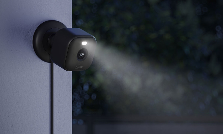 Image of the Blink Mini 2 outdoors with its LED spotlight activated.
