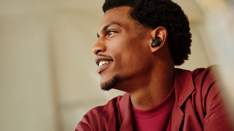 A person wearing the Bose QuietComfort Ultra Earbuds (second-gen).