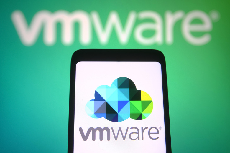 KIEV, UKRAINE - 2021/12/27: In this photo illustration, VMware Inc. logo of a cloud computing and virtualization technology company is seen on a smartphone and in the background. (Photo Illustration by Pavlo Gonchar/SOPA Images/LightRocket via Getty Images)