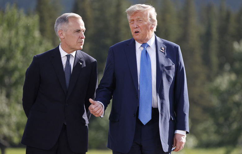 (L-R) Canadian Prime Minister Mark Carney and US President Donald Trump talk during a family photo during the Group of Seven (G7) Summit at the Kananaskis Country Golf Course in Kananaskis, Alberta, Canada on June 16, 2025. (Photo by Ludovic MARIN / POOL / AFP) (Photo by LUDOVIC MARIN/POOL/AFP via Getty Images)          