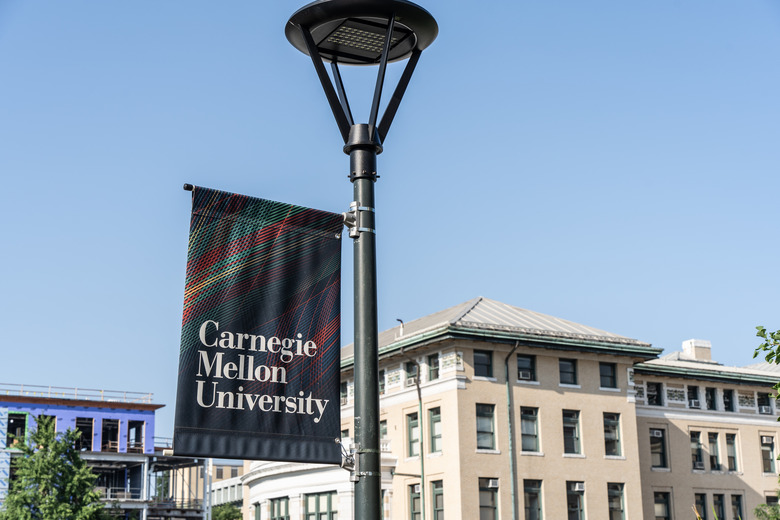 Pittsburgh, Pennsylvania  July 23, 2023: Carnegie Mellon University campus sign with school buildings in background