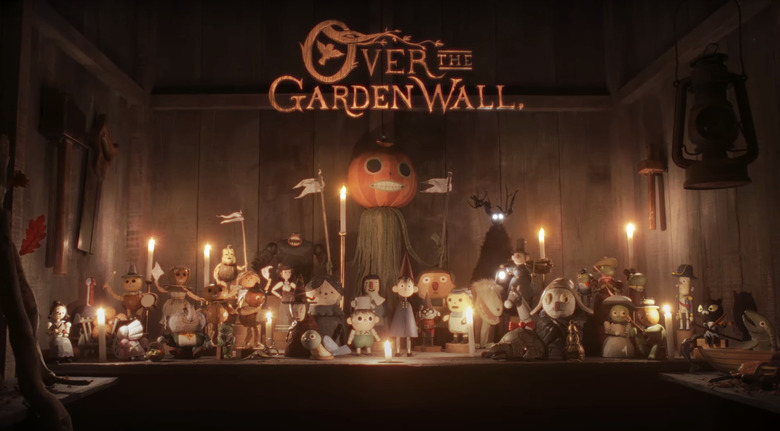A still from the stop-motion short of Over the Garden Wall showing dozens of wooden puppets depicting characters from the show, including Wirt, Greg, Beatrice and the towering pumpkin man, Enoch