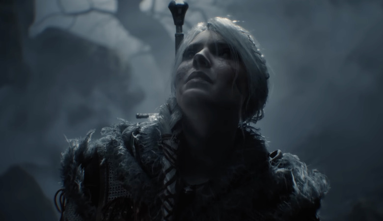A still from the cinematic trailer for The Witcher 4 showing the character Ciri up close wearing a sword on her back and looking up at the sky