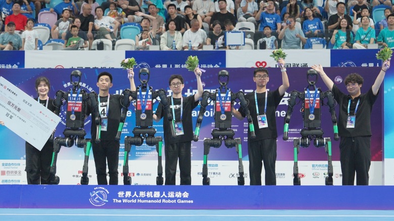 Unitree's team and robots with gold medals at the first-ever World Humanoid Robot Games in Beijing, China.