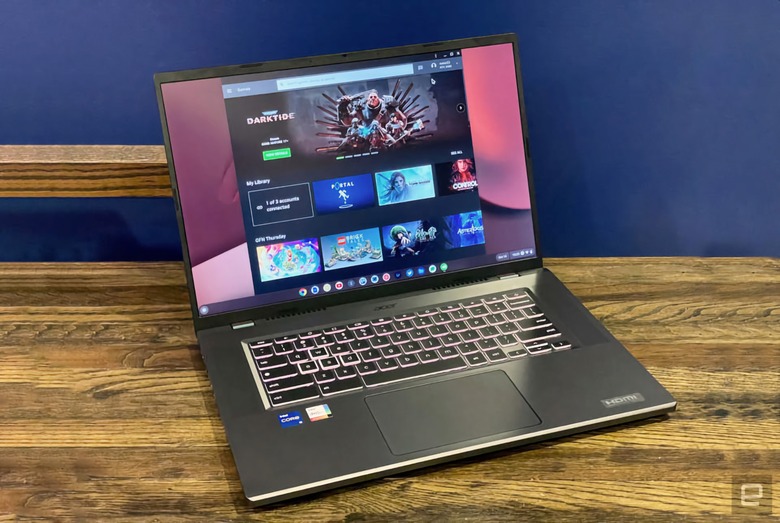 Event photography of the Acer’s Chromebook 516 GE cloud gaming laptop. It sits on a wood-grained tablet with a dark blue (with a hint of a violet background).