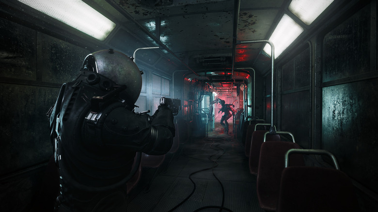 A figure wearing a helmet aims with a gun at a shadowy monster in a subway car.