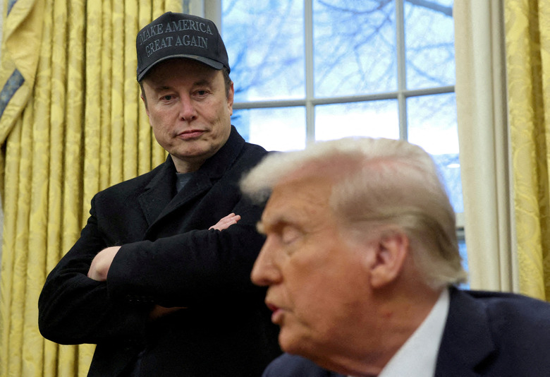 FILE PHOTO: Elon Musk listens to U.S. President Donald Trump speak in the Oval Office of the White House in Washington, D.C., U.S., February 11, 2025.   REUTERS/Kevin Lamarque/File Photo