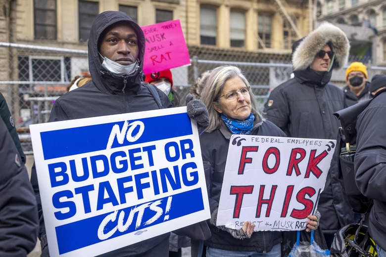 NEW YORK CITY, NEW YORK, UNITED STATES - 2025/02/19: Federal workers and protestors speak out against U.S. President Donald Trump and Elon Musk, the tech billionaire, who is leading the so-called Department of Government Efficiency (DOGE), and their push to gut federal services and impose mass layoffs. Protests have spread in cities across the nation against the Trump administration's freezing of federal funds, mass layoffs, and a disregard of union contracts. (Photo by Michael Nigro/Pacific Press/LightRocket via Getty Images)