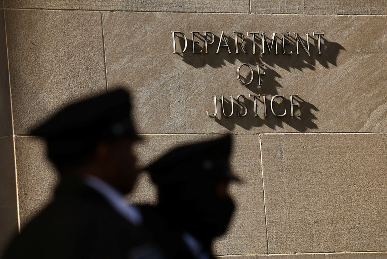 Police stand guard at the U.S. Department of Justice in Washington, D.C., April 6, 2026. REUTERS/Kevin Lamarque