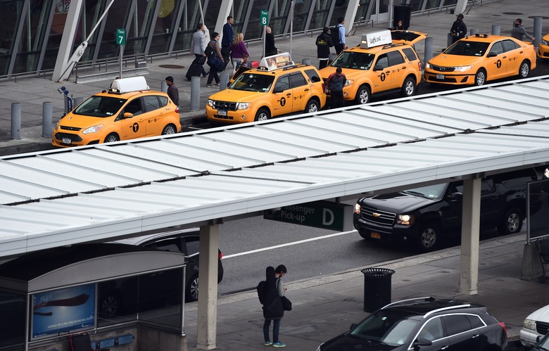 Arriving passengers line up to get taxi outside of Terminal 4 at the JFK airport in New York on October 11, 2014. The airport started health screenings for travelers arriving from Ebola-hit West African nations on October 11, as the death toll from the deadly virus topped 4,000. Passengers arriving from Liberia, Sierra Leone and Guinea will have their temperatures taken, be assessed for signs of illness and answer questions about their health and exposure history, the US Centers for Disease Control and Prevention (CDC) said.   AFP PHOTO/Jewel Samad        (Photo credit should read JEWEL SAMAD/AFP via Getty Images)