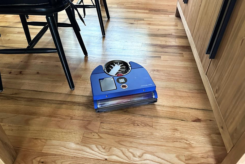 A robovac on the floor.