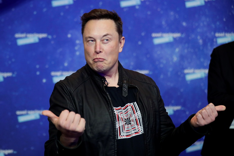 SpaceX owner and Tesla CEO Elon Musk grimaces after arriving on the red carpet for the Axel Springer award, in Berlin, Germany, December 1, 2020. REUTERS/Hannibal Hanschke/Pool