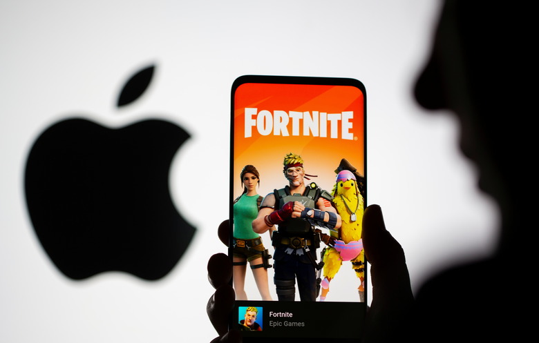 Fortnite game graphic is displayed on a smartphone in front of Apple logo in this illustration taken May 2, 2021. REUTERS/Dado Ruvic/Illustration