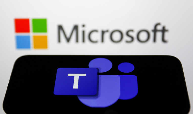 Microsoft Teams logo displayed on a phone screen and Microsoft logo displayed on a screen in the background are seen in this illustration photo taken in Krakow, Poland on May 26, 2022. (Photo Illustration by Jakub Porzycki/NurPhoto via Getty Images)