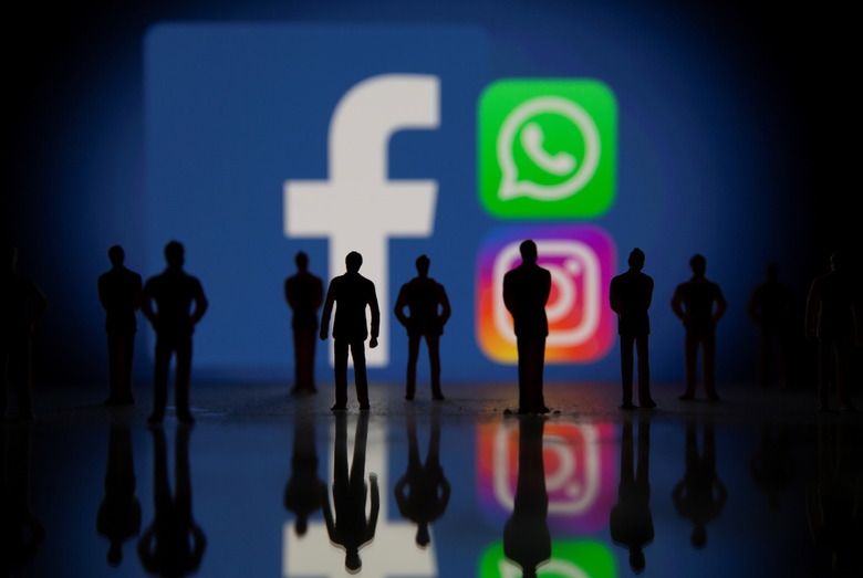 Small toy figures are seen in front of displayed Facebook, Whatsapp and Instagram logos in this illustration taken October 4, 2021. REUTERS/Dado Ruvic/Illustration
