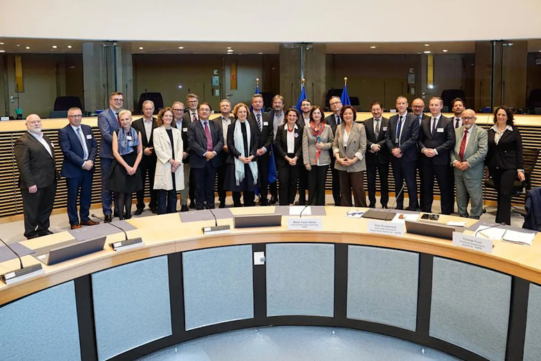 European Commission members posing for a group photo in their chamber.